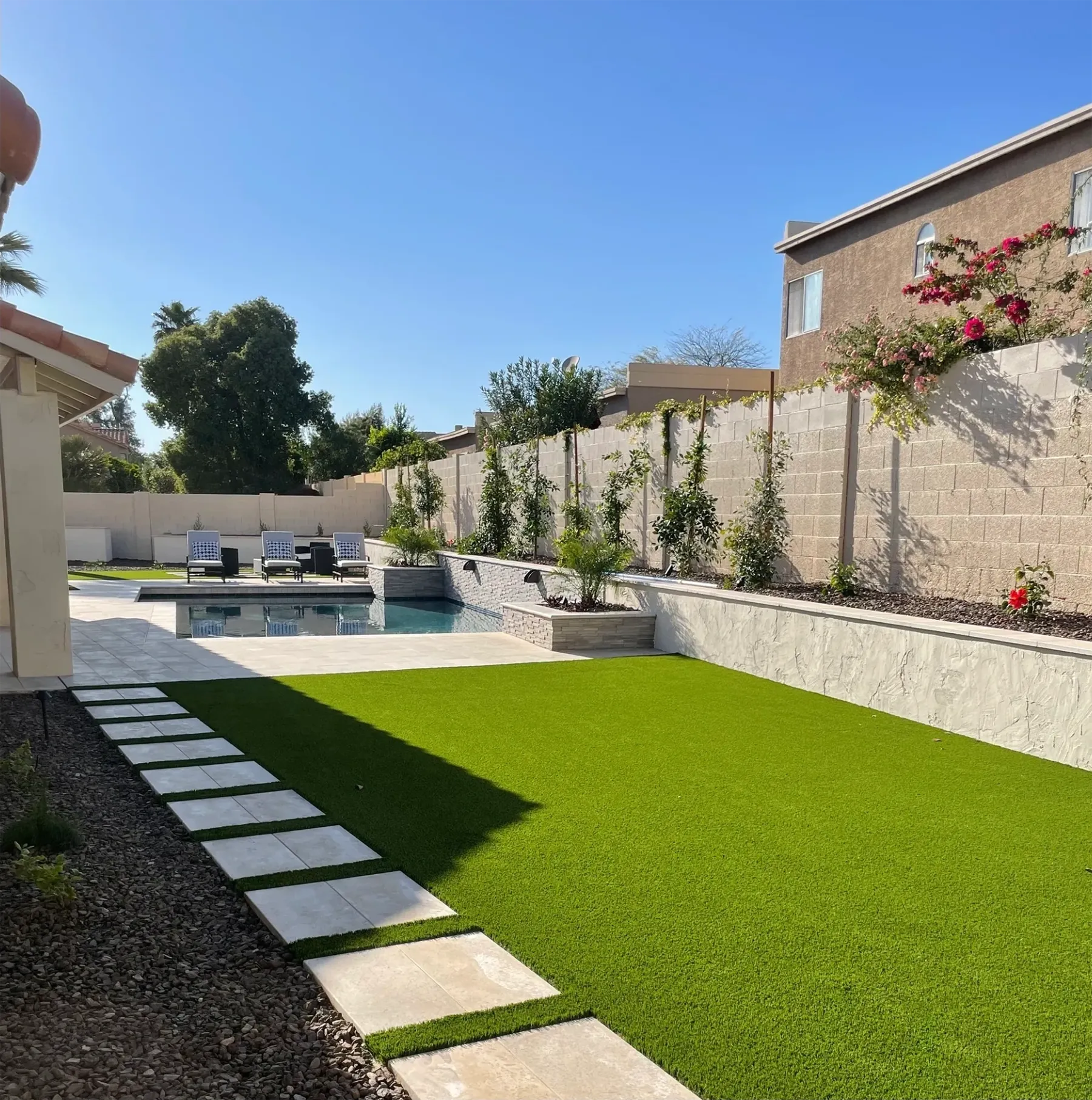 Synthetic grass, pool, pavers and new landscaping.