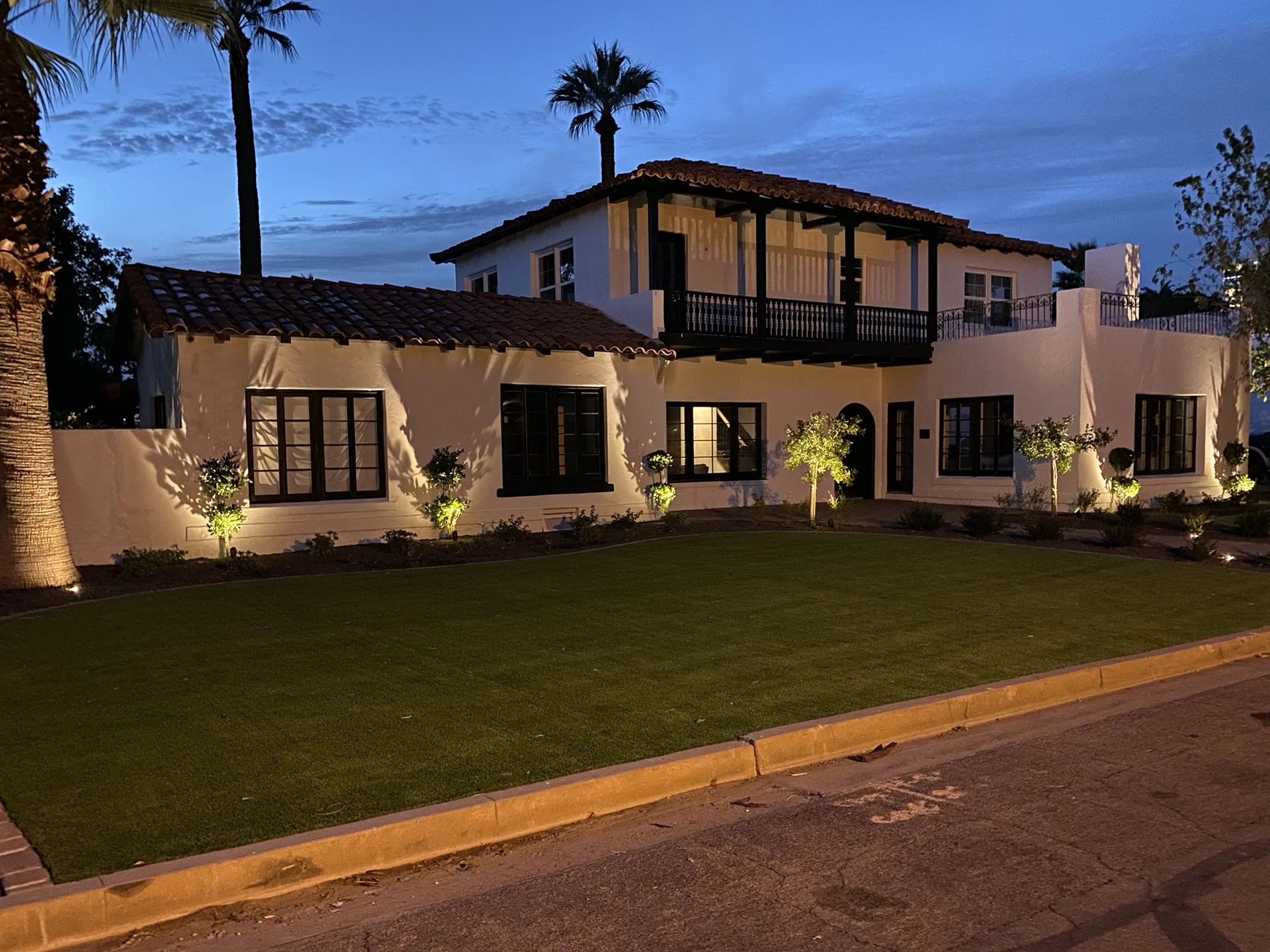 Home at night with amazing lighting and landscaping.