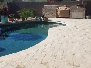 Hardscaping, pool decking, grill and pool.