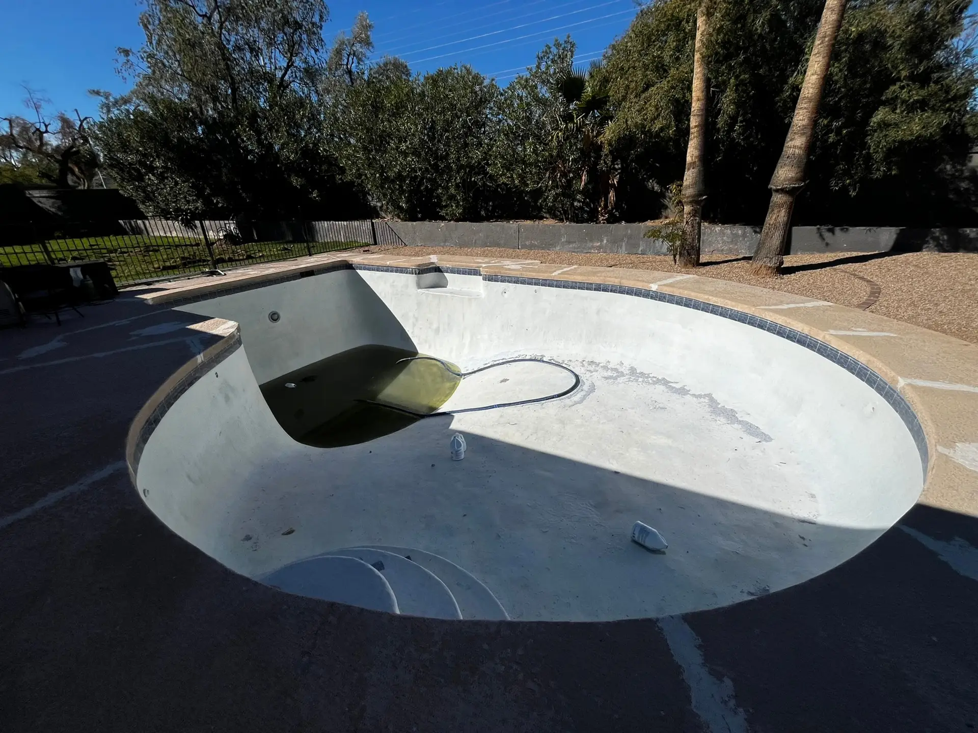 Old and unfilled pool in backyard